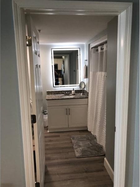 3000 Ocean Blvd N Unit 508, Myrtle Beach, SC 29577 - bathroom featuring vanity, wood finished floors, and curtained shower