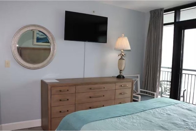 3000 Ocean Blvd N Unit 508, Myrtle Beach, SC 29577 - bedroom featuring multiple windows, baseboards, and access to exterior