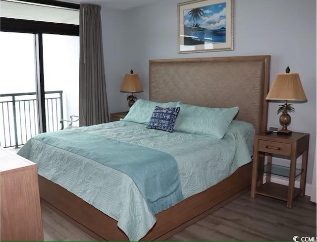 3000 Ocean Blvd N Unit 508, Myrtle Beach, SC 29577 - bedroom with wood finished floors, multiple windows, and access to outside