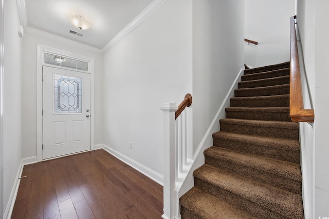 entrance foyer with baseboards, dark wood finished floors, stairway, and ornamental molding