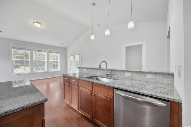 kitchen featuring dishwasher, a sink, lofted ceiling, dark wood-style flooring, and light stone counters