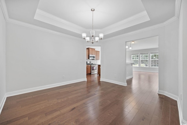 unfurnished dining area featuring a chandelier, a raised ceiling, dark wood finished floors, baseboards, and crown molding