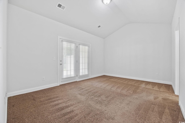 unfurnished room with lofted ceiling, carpet flooring, and baseboards
