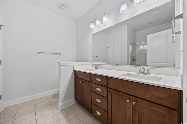 full bathroom featuring a shower stall, baseboards, tile patterned flooring, and double vanity