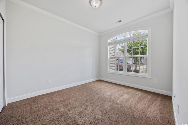 unfurnished room with carpet, crown molding, and baseboards