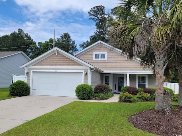 view of front of property featuring a garage, concrete driveway, and a front lawn