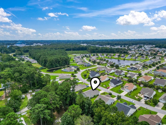 aerial view of residential area featuring a large body of water