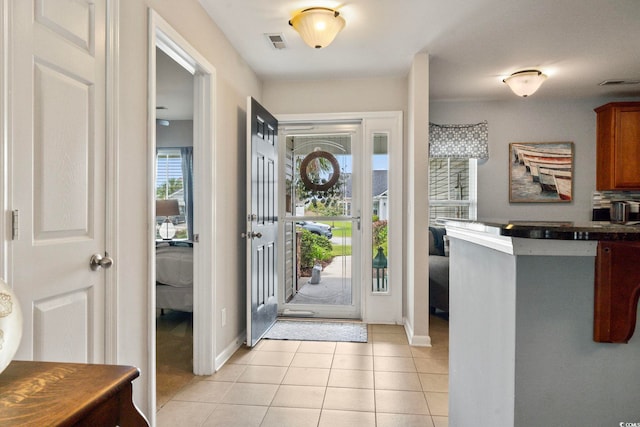 entrance foyer with light tile patterned flooring and baseboards