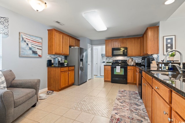 kitchen featuring black appliances, a sink, tasteful backsplash, and light tile patterned flooring