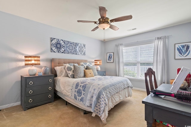 bedroom with baseboards, light colored carpet, and a ceiling fan