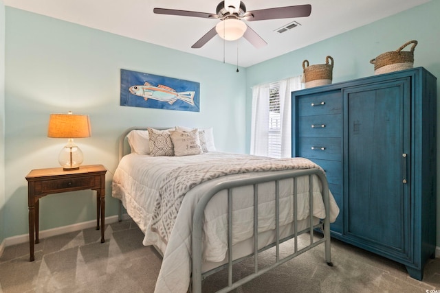 carpeted bedroom featuring baseboards and a ceiling fan