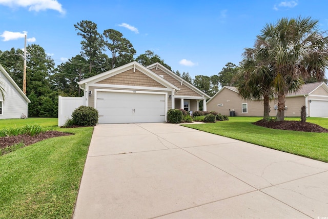 view of front facade featuring a front lawn, driveway, and an attached garage