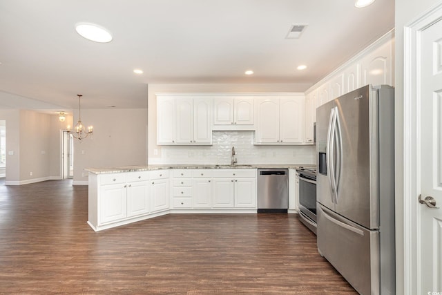 1435 Saint Thomas Cir Unit E-1, Myrtle Beach, SC 29577 - kitchen featuring stainless steel appliances, a peninsula, a chandelier, white cabinets, and recessed lighting