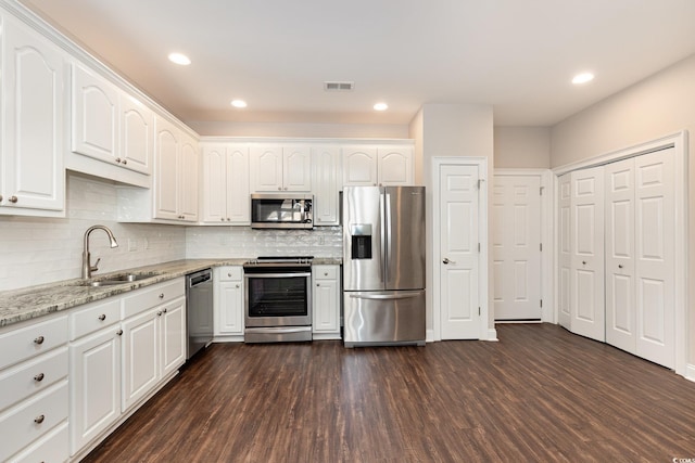 1435 Saint Thomas Cir Unit E-1, Myrtle Beach, SC 29577 - kitchen featuring appliances with stainless steel finishes, a sink, dark wood finished floors, white cabinetry, and recessed lighting