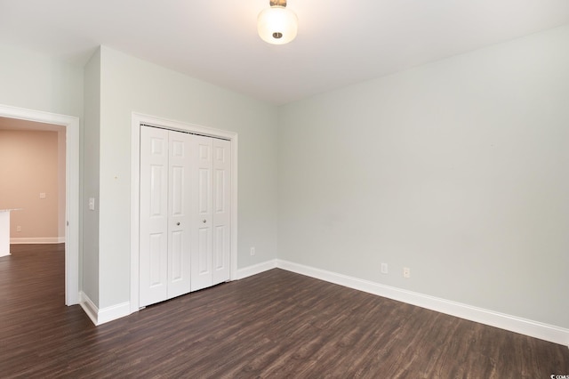 1435 Saint Thomas Cir Unit E-1, Myrtle Beach, SC 29577 - unfurnished bedroom featuring dark wood-style floors, baseboards, and a closet