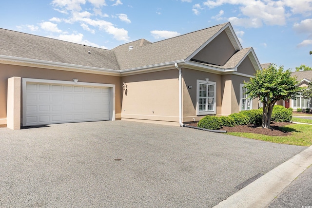 1435 Saint Thomas Cir Unit E-1, Myrtle Beach, SC 29577 - view of front of property featuring stucco siding, a garage, and driveway