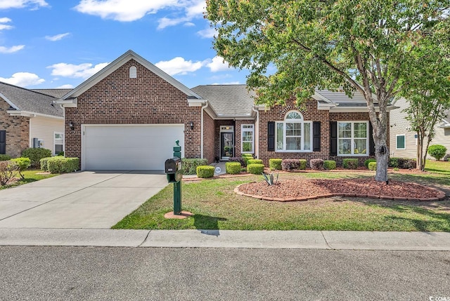 view of front of house with brick siding, a garage, driveway, and a front lawn