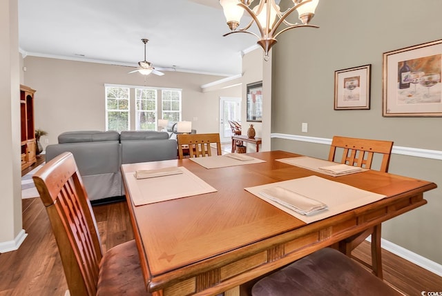 dining area with a ceiling fan, wood finished floors, a chandelier, and baseboards