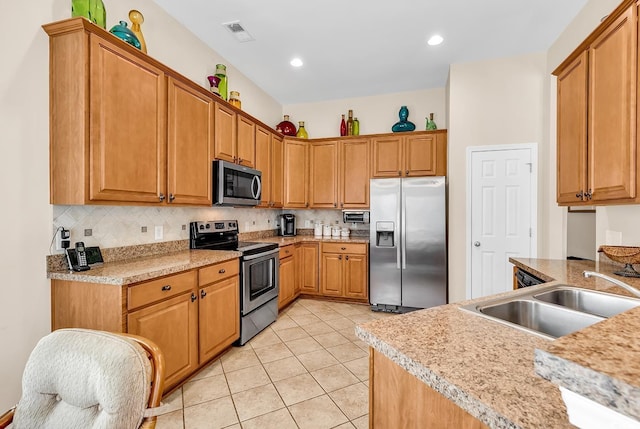 kitchen with stainless steel appliances, a sink, light countertops, light tile patterned floors, and recessed lighting