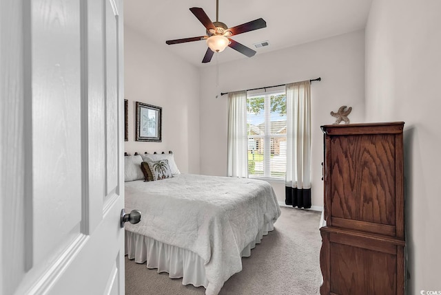 bedroom with light colored carpet, baseboards, and a ceiling fan