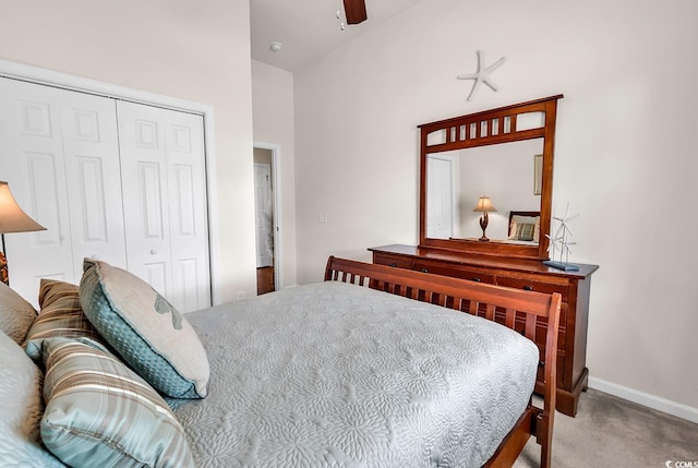 bedroom featuring carpet floors, a closet, baseboards, and a ceiling fan