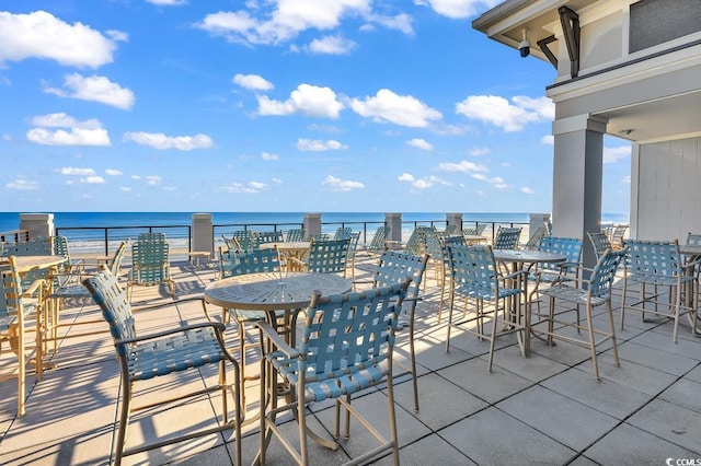 view of patio / terrace with a water view and a balcony
