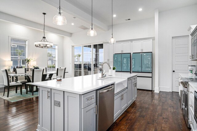 kitchen featuring stainless steel appliances, gray cabinetry, dark wood-style floors, light countertops, and recessed lighting