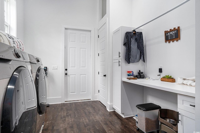 laundry room featuring washing machine and dryer, dark wood-style floors, and baseboards