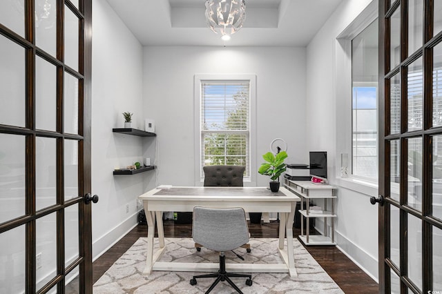 home office with baseboards, dark wood finished floors, french doors, and a tray ceiling