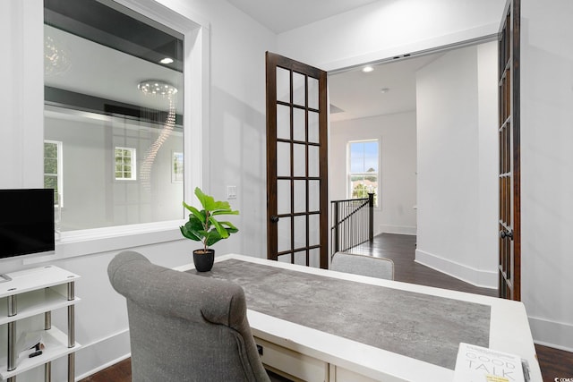 home office with dark wood-style flooring and baseboards
