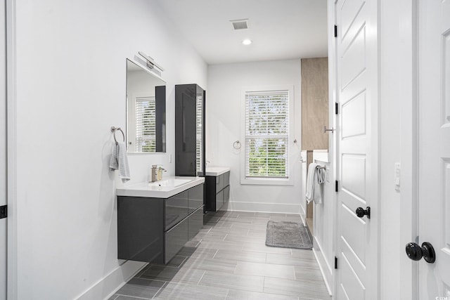 full bath featuring baseboards, vanity, and recessed lighting