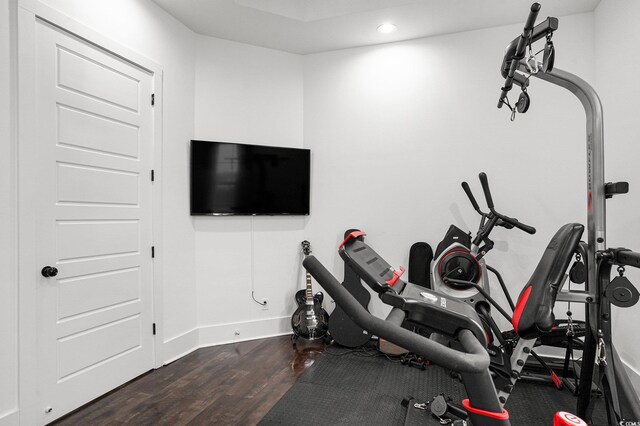workout area featuring dark wood-style floors, baseboards, and recessed lighting