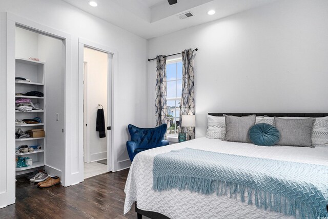 bedroom featuring dark wood finished floors, recessed lighting, and ensuite bathroom