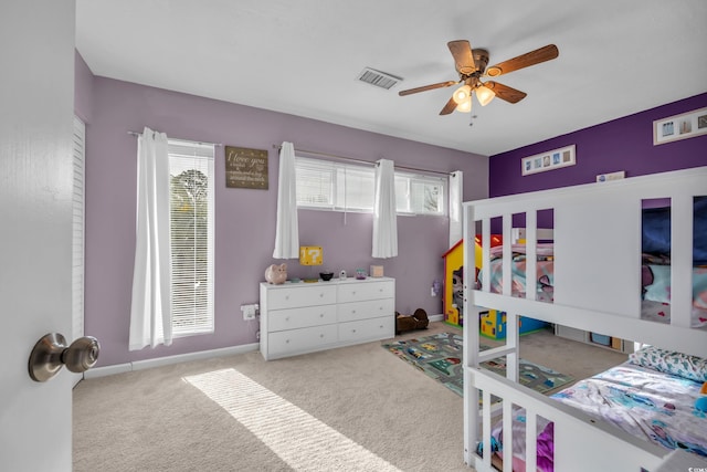 carpeted bedroom featuring a ceiling fan and baseboards
