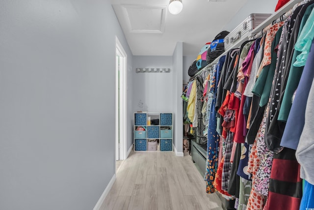 spacious closet featuring attic access and wood finished floors