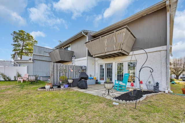 back of property featuring a balcony and a patio area