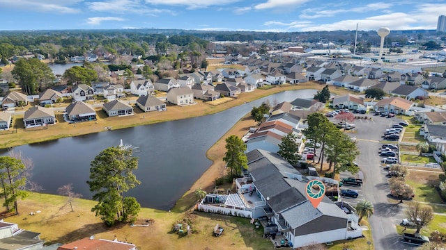 aerial view of property's location featuring a nearby body of water and nearby suburban area