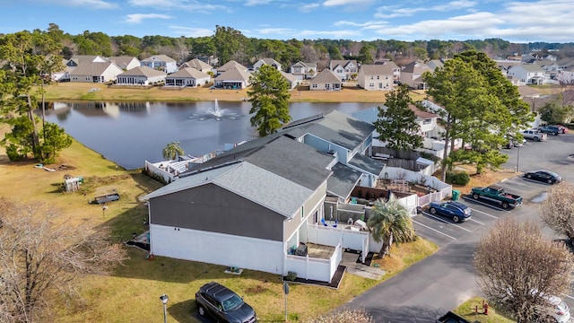 aerial view of residential area featuring a large body of water