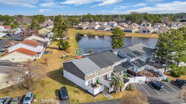 aerial view of residential area featuring a large body of water