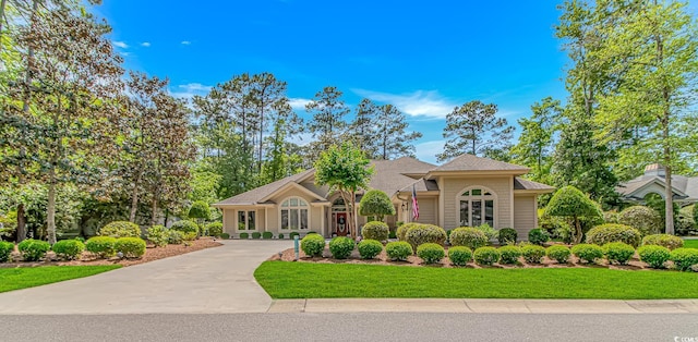 1206 Spinnaker Dr, North Myrtle Beach, SC 29582 - view of front of house featuring a front yard, concrete driveway, and roof with shingles