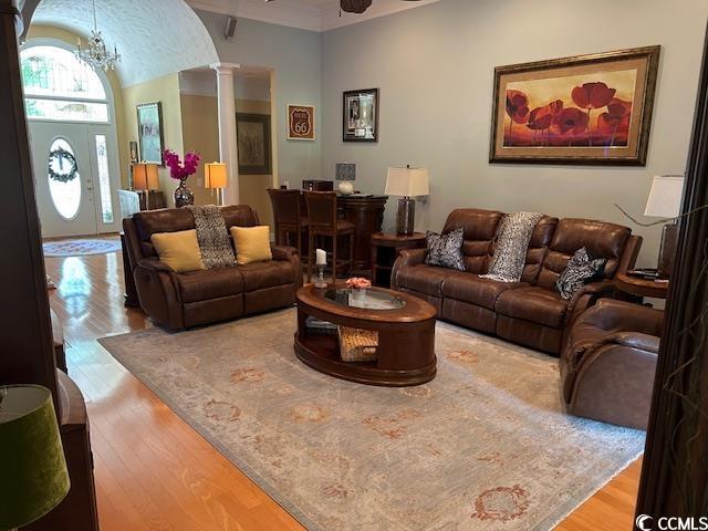 1206 Spinnaker Dr, North Myrtle Beach, SC 29582 - living room with wood finished floors, ornate columns, and a chandelier