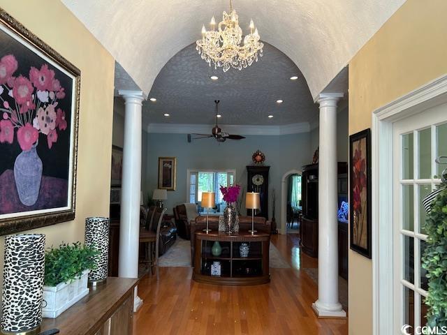 1206 Spinnaker Dr, North Myrtle Beach, SC 29582 - hall with decorative columns, wood finished floors, crown molding, and a chandelier