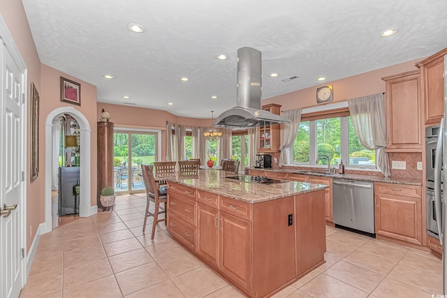 1206 Spinnaker Dr, North Myrtle Beach, SC 29582 - kitchen with plenty of natural light, island exhaust hood, a center island, recessed lighting, and light stone countertops