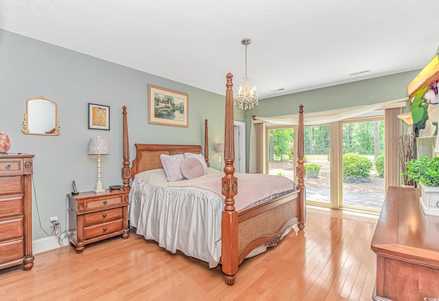 1206 Spinnaker Dr, North Myrtle Beach, SC 29582 - bedroom featuring access to exterior, light wood-style floors, and a chandelier