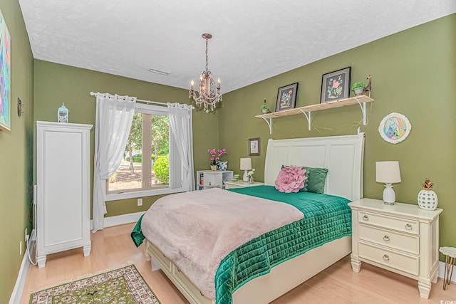 1206 Spinnaker Dr, North Myrtle Beach, SC 29582 - bedroom featuring a chandelier and wood finished floors