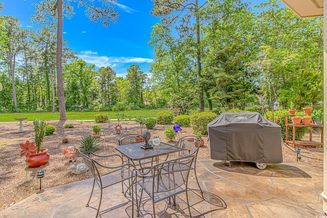 1206 Spinnaker Dr, North Myrtle Beach, SC 29582 - view of patio / terrace featuring grilling area, outdoor dining area, and view of scattered trees