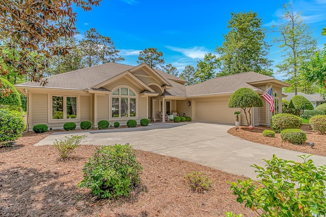 1206 Spinnaker Dr, North Myrtle Beach, SC 29582 - ranch-style home featuring a shingled roof, a garage, and driveway