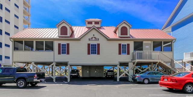 1206 Spinnaker Dr, North Myrtle Beach, SC 29582 - view of property featuring uncovered parking and stairs