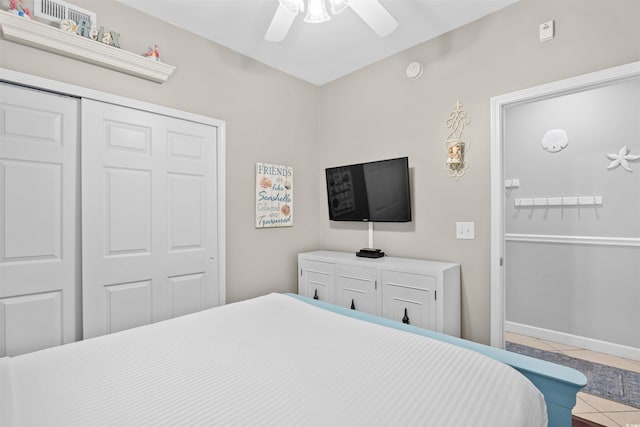 3401 N Ocean Blvd Unit 309, North Myrtle Beach, SC 29582 - bedroom with tile patterned floors, a closet, a ceiling fan, and baseboards