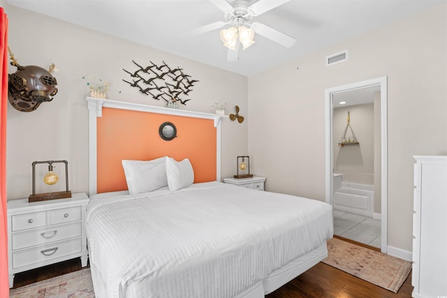 3401 N Ocean Blvd Unit 309, North Myrtle Beach, SC 29582 - bedroom featuring wood finished floors, ensuite bath, and a ceiling fan